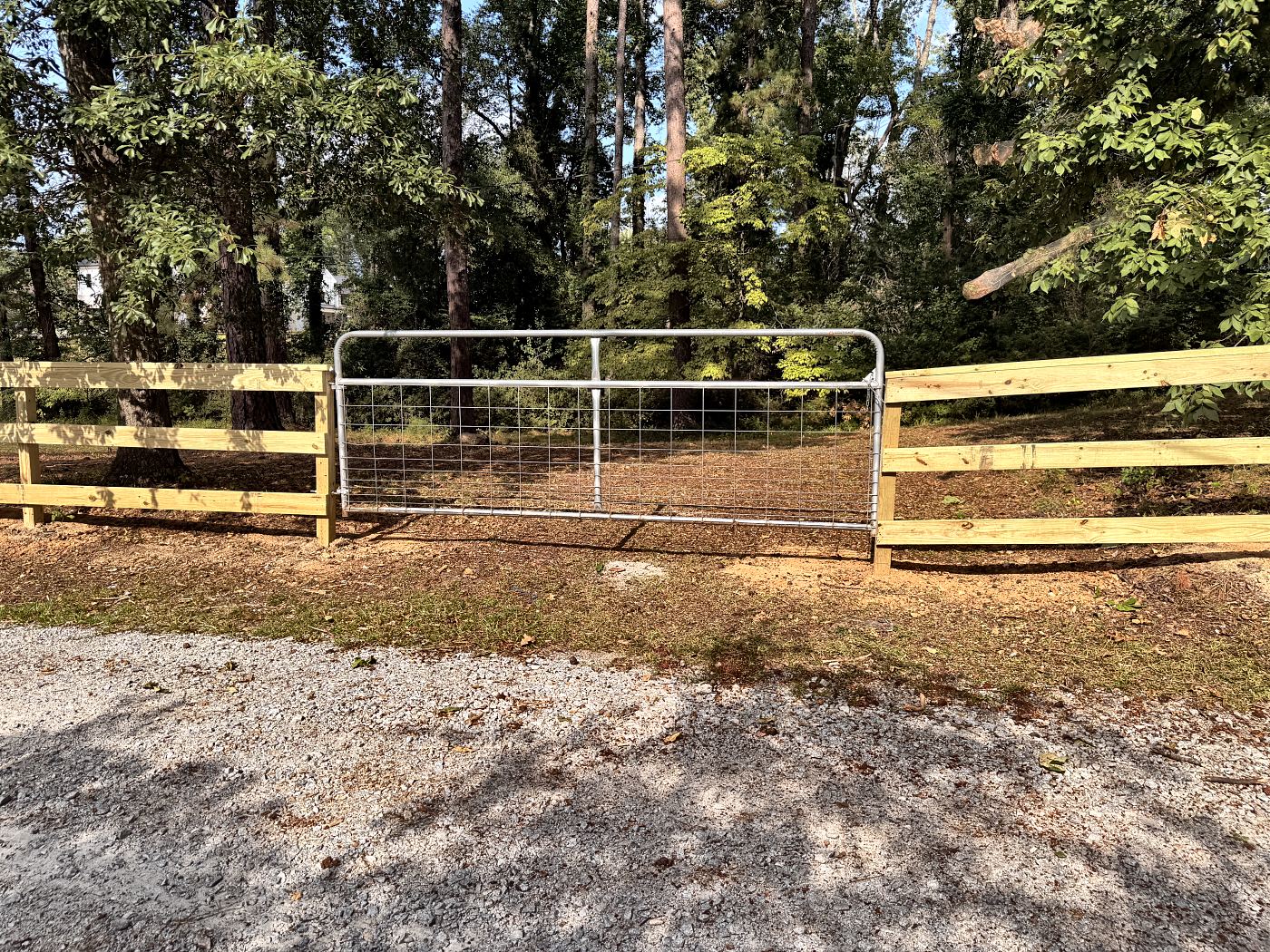Close-up of a pressure-treated split rail post set in concrete two feet deep in West Columbia, SC — Precision Palmetto
