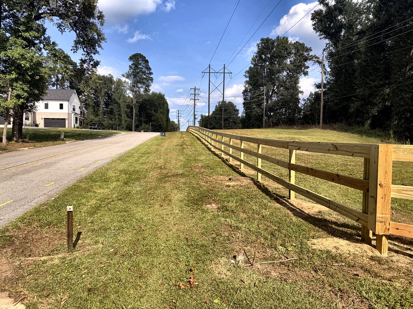 Split rail fence with top rail along a wooded property line in West Columbia, SC — Precision Palmetto