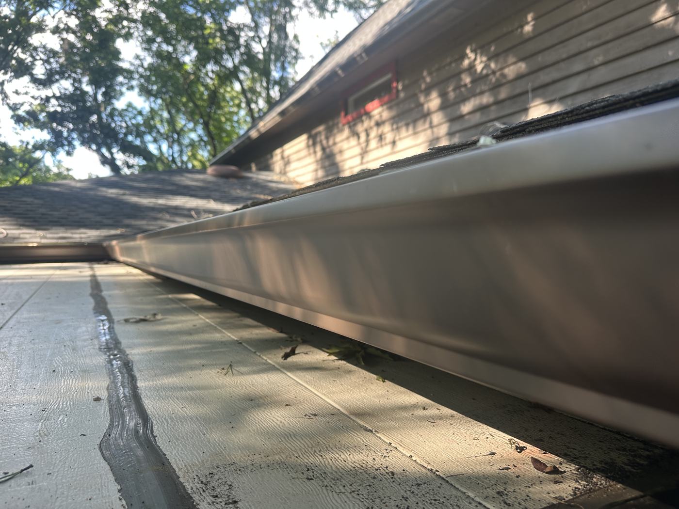 Brown seamless gutter — clean lines, matched to the home — Precision Palmetto, Columbia SC
